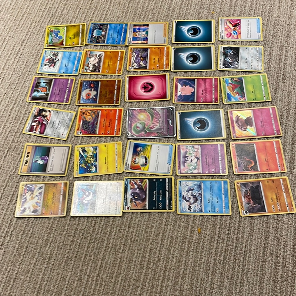 30 Pokémon cards. One V card and three holos.